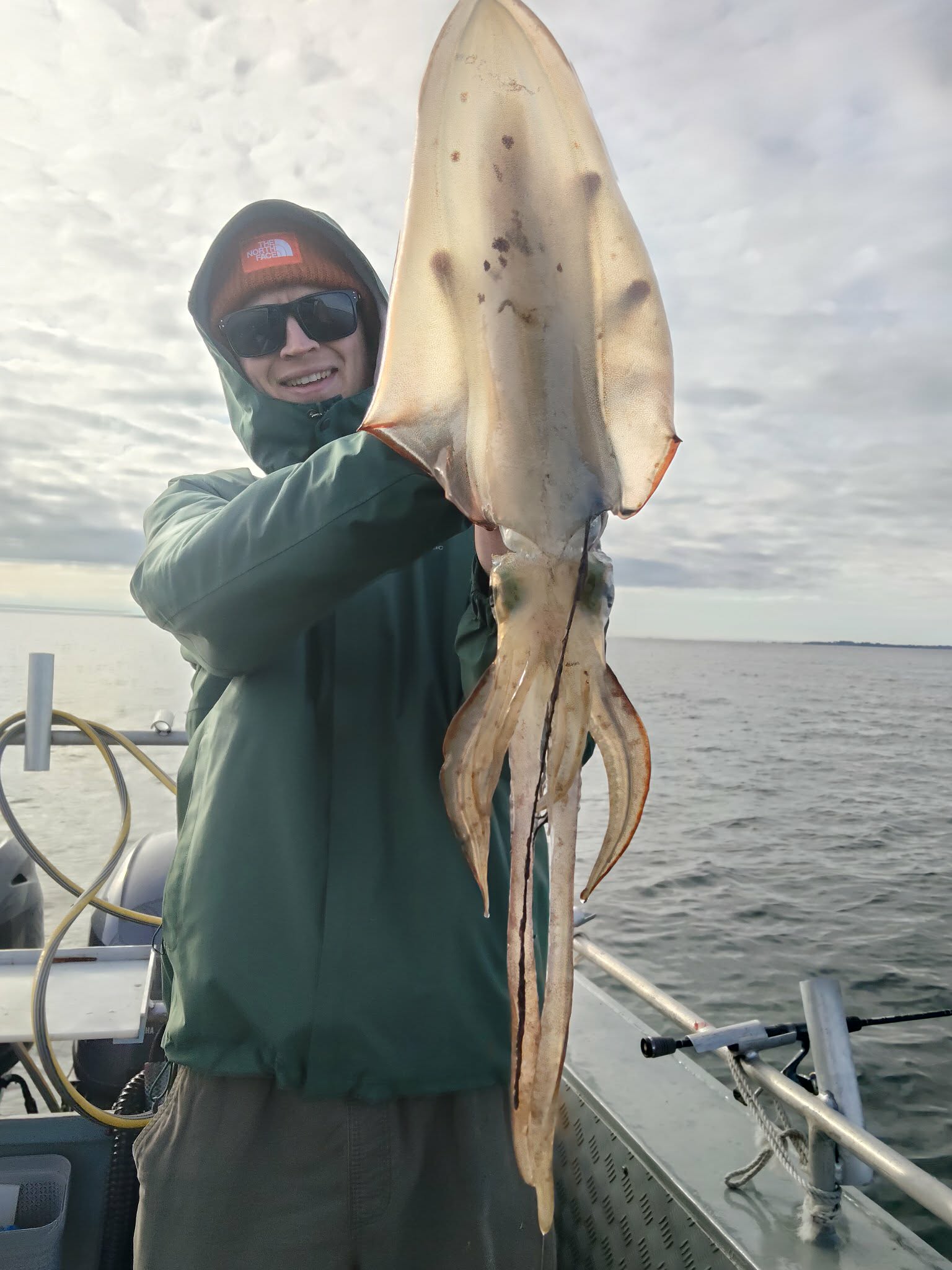 Close view of an angler holding a very large squid