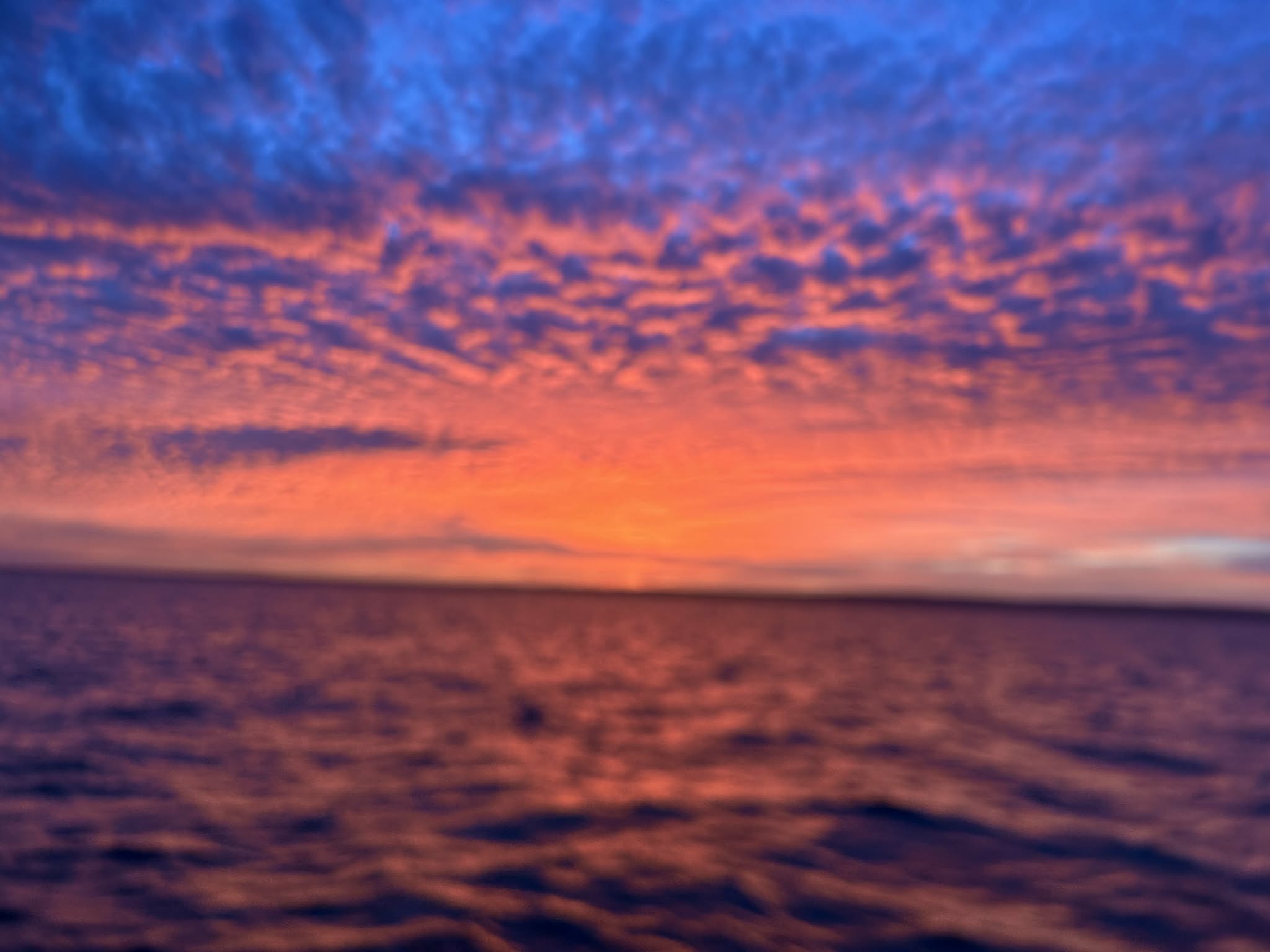 Vibrant red and blue sunrise over the water